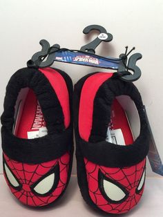 a pair of red and black shoes with spider - man on them