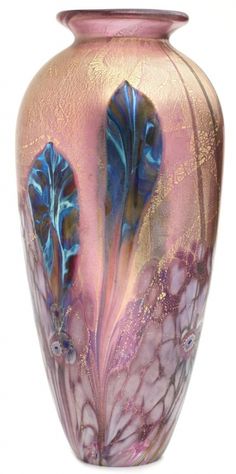 a pink vase with blue and purple designs on the outside, sitting against a gray background