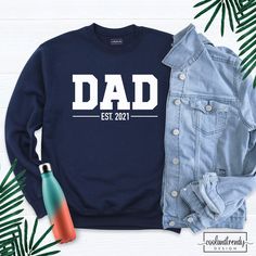 Dad Est 2021 Sweatshirt, Custom Dad Sweatshirt, Custom Date Sweatshirt, Dada Sweatshirt, Personalized Father Shirt, Est Date Dad Shirt. Hi! Welcome to our store. It's good to see you here. IMPORTANT MATTERS FOR ORDERING: 1-) Please check and review all photos. 2-) Our sizes are true to size, but can you take a look at my measurements in the product details section to make sure you get the best fit? The measurement is from armpit to armpit. Please let me know if you have any questions. BUSINESS D White Long Sleeve T-shirt For Father's Day, Casual Crew Neck Tops For Father's Day, Father's Day Long Sleeve Relaxed Fit Sweatshirt, Father's Day Casual Graphic Sweatshirt, Casual Graphic Print Sweatshirt For Father's Day, Father's Day Casual Sweatshirt With Name Print, Father's Day Relaxed Fit Letter Print Sweatshirt, Father's Day Letter Print Relaxed Fit Sweatshirt, Father's Day Long Sleeve Letter Print T-shirt