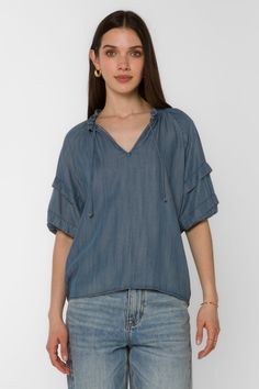 The Kenna Blouse offers an elegant style with its smocked neck, pleated elbow puff sleeve, and V-neck. It's perfect for dressier occasions, while still remaining comfortable and easy to wear. Material: 100% Tencel™ Eco-Friendly Color: 405 Malibu Machine wash cold or hand wash Model is 5'9" and wearing a size S Imported Spring V-neck Peasant Top With Blouson Sleeves, Summer Flutter Sleeve Top With Gathered Sleeves, Summer Tops With Gathered Flutter Sleeves, Spring V-neck Smocked Top With Gathered Sleeves, Spring Short Sleeve Smocked Top, Spring Smocked Top With Short Sleeves And Flowy Fit, Flowy Smocked Top With Short Sleeves For Spring, Chic V-neck Smocked Top With Blouson Sleeves, Casual Summer Blouse With Pleated Sleeves