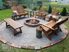 an outdoor fire pit surrounded by wooden chairs