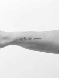 a black and white photo of a person's arm with a tattoo on it