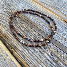 Tiny Red Creek Jasper Beaded Anklet or Bracelet: This boho chic ankle/bracelet is perfect for all occasions. The various shades of color make this a very versatile piece of jewelry that will go with many different outfits. Dress up or down! Materials: * Red Creek Jasper Beads - 2mm * Easy to Use Copper Lobster Clasp Choose your length at checkout! Matching Necklace: https://www.etsy.com/listing/960287596/small-beaded-necklace-red-creek-jasper Bohemian Double Strand Bracelet With Colorful Beads, Brown Gemstone Beads Bracelets For Festival, Brown Gemstone Beaded Bracelets For Festival, Festival Brown Beaded Bracelets With Gemstone, Adjustable Double Strand Bohemian Beaded Bracelets, Festival Brown Gemstone Beaded Bracelets, Adjustable Double Strand Bracelets With Colorful Beads, Adjustable Double Strand Colorful Beads Bracelet, Colorful Beads Double Strand Bracelet