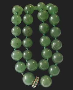 Now here's a lovely vintage Jade bead necklace! The beads have great hues and transparency. The green has darker speckles. Beads range from 8.25mm to 9.75mm. This is a collar with a length of 15 inches long. Total weight is 52.5 grams. This has a beautiful 14K gold emerald clasp. Tested to assure the golds purity. You push down on the smaller section of the round disc and slowly pull out the large bead. Elegant and sleek! A timeless beauty this strand will never go out of style! You'll be delighted adding this to your collection. In good vintage condition. Some small chips to the emeralds. Not noticed when worn but noted for accuracy. Please make sure to ask all necessary questions prior to purchase. Thank you! Jade Bead Necklace, Jade Beads, Bead Necklace, Out Of Style, Vintage Necklace, Timeless Beauty, Necklace Etsy, Jade, Emerald