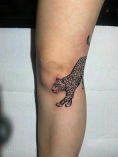 a woman's leg with a tattoo of a leopard on it