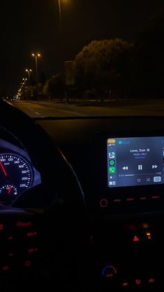 the dashboard of a car at night time