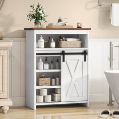 a white cabinet with doors and shelves in a bathroom