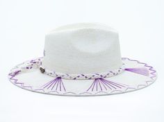 White Palm Straw Hat with Purple TCU Inspired Design on Brim by Corazon Playero. Custom designed and hand made hats by artisans in San Jose Del Cabo, Mexico. These hats are one size fits most with an elastic band inside to add comfort and fit for all head sizes. Each hat has a 3-4 week turnaround. Please note, all hats come with natural braid unless custom braid is purchased. White Woven Fedora With Curved Brim, Handmade Toquilla Straw Panama Hat With Curved Brim, White Woven Fedora With Flat Brim, White Woven Flat Brim Fedora, Adjustable White Handwoven Sun Hat, White Artisan Hat For Kentucky Derby, Handmade Fedora Panama Hat In Toquilla Straw, Handmade Fedora Hat Band From Toquilla Straw, White Woven Brimmed Hat Bands