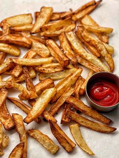 some french fries with ketchup on the side