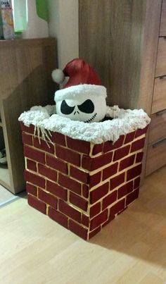 a santa hat is sitting on top of a brick wall in the middle of a room