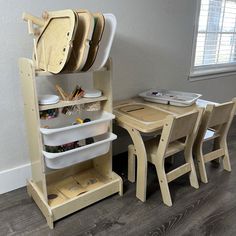 a child's wooden table and chairs in a room