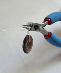 a pair of pliers with small buttons attached to them