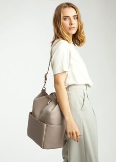 Stevie Midi is gender-neutral, edgy, and has the space to hold just the essentials. From a hike to the store, from work to the park, her eight internal pockets and easy-to-clean microfiber vegan leather make her the perfect bag to take just about anywhere. This ‘just right size’ is ideal for the mama who’s ready to downsize, and who likes nice things yet doesn’t want to fear the rough & tumble. Stevie’s all about options – her backpack converts to a shoulder strap, and her intuitive internal org Functional Large Capacity Leather Backpack For On-the-go, Versatile Everyday Duffle Bag With Functional Pockets, Versatile Duffle Bag With Functional Pockets For Everyday, Functional Leather Backpack With Adjustable Strap For Everyday, Everyday Softback Bags With Functional Pockets, Everyday Bags With Functional Pockets And Softback, Functional Large Capacity Leather Backpack, Urban Everyday Bag With Removable Pouch, Urban Bag With Removable Pouch For Everyday Use