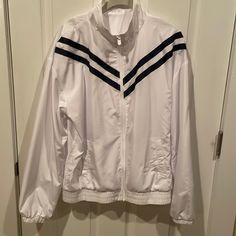 Zyia White And Navy Stripes By Shoulders Light Wind Breaker Jacket. Great For Spring And Fall. Size: Xl Material: 100% Polyester. Lining: 100% Polyester. Machine Wash - Cold Temperature. Do Not Tumble Dry Or Used Bleach. Condition: Brand New - Never Worn. Measurements: Length: 25”. Pit-To-Pit. 24”. Sleeve Length: 23” White Oversized Sporty Windbreaker, Oversized White Long Sleeve Track Jacket, Sporty White Oversized Windbreaker, Casual Oversized White Track Jacket, White Long Sleeve Track Jacket For Spring, Windbreaker Jacket Women, White Windbreaker, Active Jacket, Cold Temperature