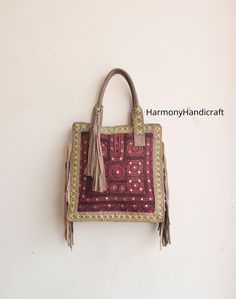 Welcome to HarmonyHandicraftCo Banjara shoulder bag is large enough to hold everything you need throughout your day, Made of antique hand-embroidered Banjara Patch and Leather Thread textiles, with intricate embellishments, bag is truly unique. Size in Inches ( Approx ) Height with handle -25 Height - 16" Width - 15" Sides - 4" Inside Pocket - 3 Outside Pocket - No Closure - Zipper This Bag is made from Leather and hand embroidered Kutchi tribal fabrics which features multi color mirror work, sequins, Beautiful patchwork of colorful hand embroidered work. These multi color cotton shoulder bags are brilliantly embroidered with leather strap. Very colorful and striking color purse, It can be a unique gift for girls, girl friends, sisters, daughters. Housewives, and can a perfect match with a Traditional Handheld Bag For Daily Use, Rectangular Hobo Bag For Everyday Use And Festivals, Daily Use Rectangular Shoulder Bag With Tassels, Handmade Tote Shoulder Bag For Festivals, Traditional Brown Handheld Shoulder Bag, Handmade Rectangular Shoulder Bag For Festivals, Traditional Satchel For Everyday Use, Embroidered Rectangular Shoulder Bag For Festivals, Rectangular Embroidered Shoulder Bag For Festivals