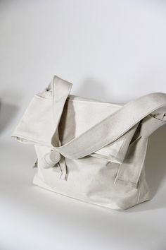 This clutch is crafted from 100% sustainable eco-cotton, in an Off-white upcycled denim material. Perfect for everyday use, to hold all of your essentials. Casual Ethically Sourced Shoulder Bag For Everyday Use, Casual Ethically Sourced Shoulder Bag For Daily Use, Eco-friendly White Shoulder Bag With Adjustable Strap, Modern Cotton Shoulder Bag For Everyday Use, Modern White Canvas Shoulder Bag, Modern White Canvas Bag For Everyday, Casual Everyday Bags Ethically Sourced, White Cotton Shoulder Bag For On-the-go, Modern Cotton Shoulder Bag For Everyday