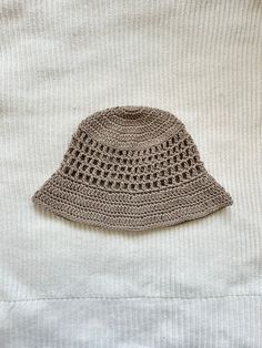 Protect yourself from the sun in style with this crocheted bucket hat with mesh-like details! This hat is made with 100% cotton yarn, so it is breathable and lightweight for warmer weather, and is washable. This listing is for an adult-sized hat in the color "taupe," more colors available in separate listings!  To clean, hand wash with cold water and lay flat to dry. Brown Lightweight Summer Bucket Hat, Lightweight Brown Bucket Hat For Summer, Beige Crochet Hat For Spring And Summer, Lightweight Beige Bucket Hat With Short Brim, Beige Lightweight Bucket Hat With Short Brim, Lightweight Beige Bucket Hat, Brown Crochet Hat With Short Brim, Summer Brimmed Hats In Neutral Color, Adjustable Neutral Hats For Summer