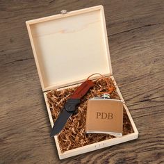 a knife and flask in a box on a table