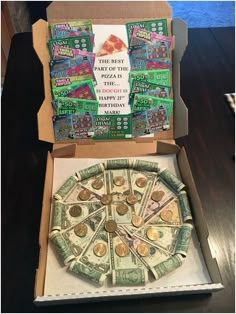 a pizza box with money in it sitting on a table