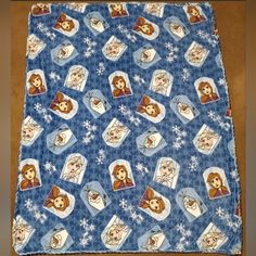 a blue blanket with pictures of princesses on it