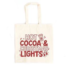 a tote bag with hot cocoa and christmas lights printed on the front in red