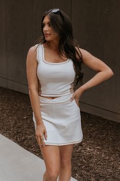 Front view of female model wearing the Hayden Cream & Mocha Tank which features Stretchy White Fabric, Taupe Side Colorblocking, Taupe Contrast Stitching, Square Neckline, Thick Straps and Cropped Waist White Color Block Sleeveless Tank Top, White Sleeveless Color Block Tank Top, Fitted Sleeveless Tank Top With Contrast Trim, White Color Block Tank Top For Summer, Chic White Stretch Tank Top, Chic Fitted Color Block Tops, Chic White Tank Top For Layering, Chic White Tank Top For Day Out, White Fitted Tank Top With Contrast Trim