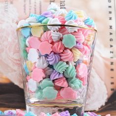 a glass filled with lots of colorful candy