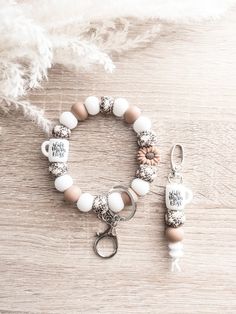 a bracelet with charms on it and a keychain hanging from the clasps