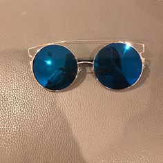 Brand New Reflective Blue Sunglasses With Gold Trimming Light Blue Mirrored Sunglasses For Beach, Modern Blue Anti-reflective Sunglasses, Modern Blue Sunglasses With Mirrored Lenses, Blue Sunglasses With Uv Protection For Beach, Blue Sunglasses With Uv Protection For The Beach, Modern Blue Cat-eye Sunglasses, Blue Polarized Glass Sunglasses, Blue Polarized Sunglasses With Glass Lenses, Blue Polarized Sunglasses For Vacation