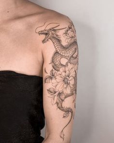 a woman with a dragon tattoo on her arm