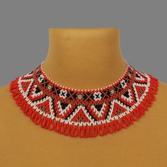 a red and black beaded necklace on a mannequin neckpiece with beads