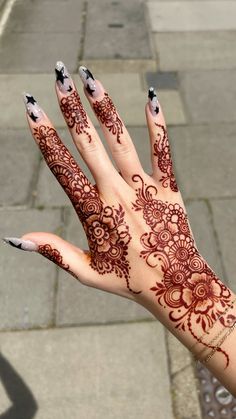 a woman's hand painted with hendix and flowers on the left palm