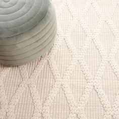 a round cushion sitting on top of a white rug