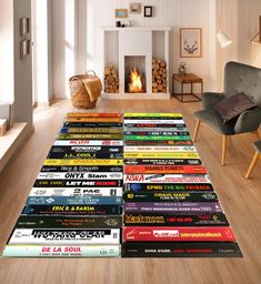 a large pile of books sitting on top of a wooden floor next to a fire place