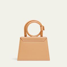 Jacquemus "Le Chiquito Noeud" top handle bag in leather  Coil top handle with snap strap closure  Detachable, adjustable crossbody strap Can be worn as a top handle or crossbody bag  Flap top with magnetic closure  Interior, one card slot  Lining: Cotton Approx. 10.8"H x 7"W x 5.5"D Made in Italy Jacquemus Le Chiquito, Handle Bag, Crossbody Strap, Magnetic Closure, Top Handle, Crossbody Bag, Top Handle Bag, Tops Designs, Italy