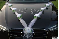 a car decorated with flowers and ribbons