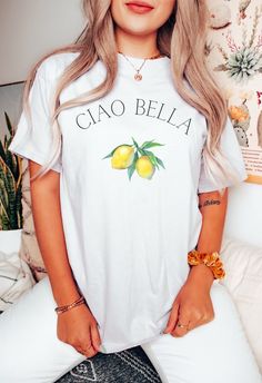 This Minimalist Ciao Bella Tee is the perfect addition to your closet!! This Italian shirt is pure comfort!  Made with high-quality fabric, it's soft, comfortable, and sure to become a staple in your wardrobe. Whether you are out on the town or relaxing at home, this t-shirt is sure to make a statement. ~HOW TO ORDER~ 1. Select a color 2. Select size (refer to size chart) 3. Add to cart 4. Select your shipping option and choose payment method to complete your order ~SHIRT DETAILS~ .: 100% ring-spun cotton .: Medium fabric (6.1 oz/yd² (206.8 g/m .: Relaxed fit .: Sewn-in twill label ~SHIPPING~ Our items are individually made with love for each costumer. Items ship between 1-7 business days. We are not responsible for any delivery delays that may be caused by the shipping service. ~RETURNS / White Print Graphic Tee With Crew Neck, Printed Graphic Tee With Crew Neck, Printed Graphic Tee Shirt With Crew Neck, White Print Funny Short Sleeve Shirt, White Short Sleeve Shirt With Funny Print, Short Sleeve Shirt With Sublimation Print, White Print Crew Neck Shirt With Letter Print, White Print Short Sleeve Graphic Tee Shirt, Cotton T-shirt With White Print