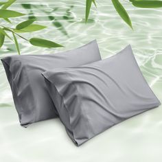 two pillows sitting next to each other in the water