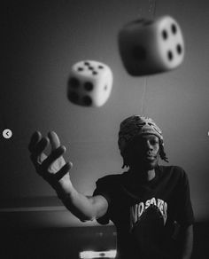 a man juggling dices into the air