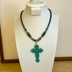 Cooling To The Touch Hematite Necklace With Tuquoise Cross Pendant And Matching Beads. Necklace Is High Quality, Substantive And Attractive. Turquoise Jewelry With Black Beads For Gift, Turquoise Necklace With Black Beads As Gift, Blue Beaded Hematite Jewelry, Blue Hematite Jewelry For Gift, Blue Hematite Jewelry As A Gift, Turquoise Beaded Necklaces With Black Beads As Gift, Gift Turquoise Beaded Necklaces With Black Beads, Turquoise Cross Pendant, Hematite Necklace