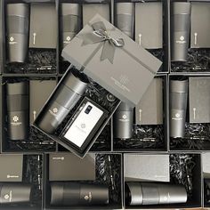 an assortment of men's colognes in black boxes with ribbons and bows on them