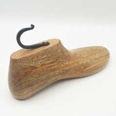 an umbrella stand made out of wood with a black handle on the top of it