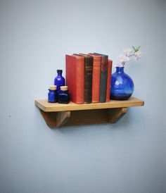 two blue vases and some books on a shelf