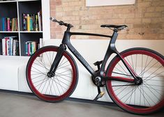 a bike is parked against the wall in front of bookshelves