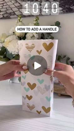 someone is opening up a gift box with hearts on it and the text how to add a handle