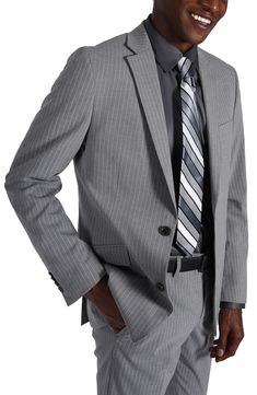 Sleek pinstripes distinguish a suit jacket and pants tailored in a trim fit for refined styling at any occasion. Jacket has notched lapels; four-button cuffs; chest pocket; flap pockets; back vent Lined 69% polyester, 29% rayon, 2% spandex Dry clean Imported Striped Tuxedo Suit For Business, Striped Semi-formal Suit, Classic Pinstripe Blazer In Suiting Fabric, Pinstripe Tuxedo Suit For Semi-formal Occasions, Formal Pinstripe Blazer With Suit Collar, Semi-formal Pinstripe Tuxedo Suit, Formal Pinstripe Suit With Welt Pockets, Tailored Pinstripe Suits For Formal Occasions, Pinstripe Tuxedo Suit For Work