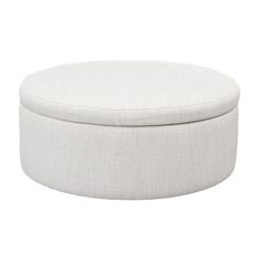 a white round ottoman sitting on top of a floor