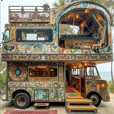 an elaborately decorated bus is parked on the beach