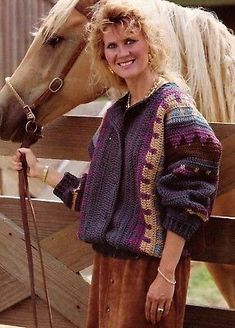 a woman standing next to a brown horse