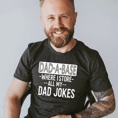 Listing: (1) Dad-A-Base Where I Store All My Dad Jokes Shirt Listing Photos: 1. Dark Heather Gray Shirt with White Lettering. 2. Black Shirt with White Lettering. 3. White Shirt with Black Lettering. Branding: Adult: Bella Canvas/Next Level *Size chart available in the photos section *Sizing is unisex and can be used for women or mens sizing. *XS size currently not available COPYRIGHT STATEMENT: -THIS IS AN ORIGINAL DESIGN OF TCCTN (www.tcctn.com) -COPYING OF THIS ORIGINAL DESIGN IS PROHIBITED © Father's Day Party, Top Ideas, Trendy Clothing, Day Party, Dad Jokes, Grey Shirt, My Dad, Party Birthday